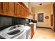 Laundry room with built-in cabinetry and modern appliances at 8100 N 68Th St, Paradise Valley, AZ 85253
