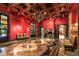 Formal dining room with red walls, wood ceiling, and marble floor at 8100 N 68Th St, Paradise Valley, AZ 85253