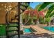 Ornate spiral staircase and a view of the pool area at 8100 N 68Th St, Paradise Valley, AZ 85253