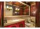 Elegant powder room with granite vanity, ornate mirror, and bidet at 8100 N 68Th St, Paradise Valley, AZ 85253