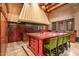 Island kitchen with red cabinetry and breakfast bar at 8100 N 68Th St, Paradise Valley, AZ 85253