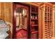 Custom wine cellar with detailed woodwork and glass door at 8100 N 68Th St, Paradise Valley, AZ 85253