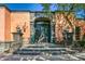 Spanish-style home with large wooden doors and lush landscaping at 8100 N 68Th St, Paradise Valley, AZ 85253