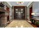 Grand entry with ornate doors, tile floors, and a fireplace at 8100 N 68Th St, Paradise Valley, AZ 85253