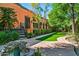 Landscaped backyard with lush lawn, fountain, and walkway at 8100 N 68Th St, Paradise Valley, AZ 85253