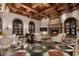 Bright living room with exposed wood beams, fireplace, and geometric tile floor at 8100 N 68Th St, Paradise Valley, AZ 85253