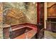 Bathroom with marble soaking tub and custom cabinetry at 8100 N 68Th St, Paradise Valley, AZ 85253