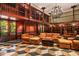 Two-story library with wood paneling, fireplace and seating area at 8100 N 68Th St, Paradise Valley, AZ 85253