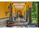 Covered patio with yellow walls, arched entryways, and stone columns at 8100 N 68Th St, Paradise Valley, AZ 85253
