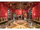 Formal dining room with red walls, wood ceiling, and marble floors at 8100 N 68Th St, Paradise Valley, AZ 85253