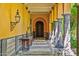 Long covered walkway with yellow walls, arched entryways, and stone columns at 8100 N 68Th St, Paradise Valley, AZ 85253