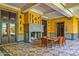 Bright sunlit indoor patio with a stone fireplace and tiled floor at 8100 N 68Th St, Paradise Valley, AZ 85253