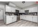 Modern kitchen with white cabinets, stainless steel appliances, and tile backsplash at 2019 E Southern Ave, Phoenix, AZ 85040