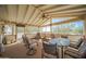 Spacious screened-in porch with wooden deck and ceiling fan at 50910 W Long Rifle Rd, Aguila, AZ 85320