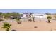 Mobile home with detached garage and palm trees at 50910 W Long Rifle Rd, Aguila, AZ 85320