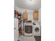 Laundry room with washer, dryer, and ample storage shelves at 50910 W Long Rifle Rd, Aguila, AZ 85320