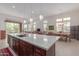 Open concept kitchen with an expansive island and views into the living and dining areas at 7325 E Paraiso Dr, Scottsdale, AZ 85255