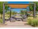 Community seating area with shaded pergola and comfortable furniture at 11129 E Ulysses Ave, Mesa, AZ 85212