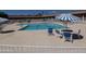 Community pool with lounge chairs and umbrellas at 7750 E Broadway Rd # 24, Mesa, AZ 85208