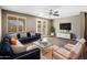 Spacious living room with comfortable seating, a large TV, and stylish decor at 1695 E Mia Ln, Gilbert, AZ 85298