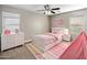 Charming bedroom with white bed frame and pink accents at 1695 E Mia Ln, Gilbert, AZ 85298