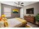 Main bedroom with a large bed and wood dresser at 1695 E Mia Ln, Gilbert, AZ 85298
