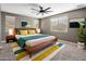 Bright bedroom with a mid-century modern bed, stylish rug, and plenty of natural light at 1695 E Mia Ln, Gilbert, AZ 85298
