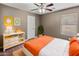 Bedroom with orange bedding and a mid-century modern dresser at 1695 E Mia Ln, Gilbert, AZ 85298