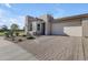 Modern home with a large driveway and neutral color scheme at 35300 N Sunset Trl, Queen Creek, AZ 85140