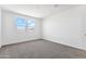 Spacious bedroom featuring gray carpet and large windows at 38155 W Excussare Way, Maricopa, AZ 85138