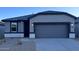 Modern single story home with gray exterior and two-car garage at 38155 W Excussare Way, Maricopa, AZ 85138