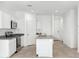 Open concept kitchen with island and stainless steel appliances at 38155 W Excussare Way, Maricopa, AZ 85138