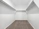 Large walk-in closet with double hanging rods and shelving at 38155 W Excussare Way, Maricopa, AZ 85138
