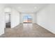 Bright living room with tile floors and sliding glass door leading to backyard at 38155 W Excussare Way, Maricopa, AZ 85138