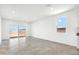 Spacious living area featuring tile floors and access to backyard at 38155 W Excussare Way, Maricopa, AZ 85138