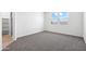 Well-lit bedroom with gray carpet and ample closet space at 38155 W Excussare Way, Maricopa, AZ 85138