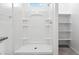 Clean shower with built-in shelving and spacious design at 38155 W Excussare Way, Maricopa, AZ 85138