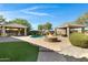 Inviting pool area with fire pit, two patios, and waterfall feature at 206 W Crimson Sky Ct, Casa Grande, AZ 85122