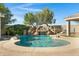 Relaxing kidney-shaped pool with a waterfall and slide at 206 W Crimson Sky Ct, Casa Grande, AZ 85122