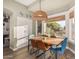 Bright breakfast nook with wooden table and four chairs, overlooking backyard at 6907 E Teton Cir, Mesa, AZ 85207