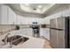 Modern kitchen with white cabinets, stainless steel appliances, and granite counters at 3800 S Cantabria Cir # 1087, Chandler, AZ 85248