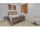 Light and airy bedroom with a wooden bed frame and neutral decor at 964 W Saguaro Ln, San Tan Valley, AZ 85143