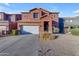 Two-story stucco home with a white garage door and landscaping at 964 W Saguaro Ln, San Tan Valley, AZ 85143