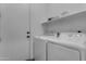 Laundry room with washer, dryer, and additional shelving at 964 W Saguaro Ln, San Tan Valley, AZ 85143