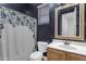 Dark-walled bathroom with a gold framed mirror and shower at 964 W Saguaro Ln, San Tan Valley, AZ 85143