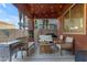 Covered patio with seating area, string lights, and grill at 964 W Saguaro Ln, San Tan Valley, AZ 85143