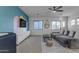 Gathering room with gray sectional sofa and accent wall at 964 W Saguaro Ln, San Tan Valley, AZ 85143