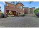 Large backyard with gravel landscaping and a two-story home at 964 W Saguaro Ln, San Tan Valley, AZ 85143
