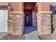 Stone columns frame the entry to this home with a black door at 964 W Saguaro Ln, San Tan Valley, AZ 85143