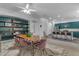 Open concept dining area with a long wooden table and pink chairs at 964 W Saguaro Ln, San Tan Valley, AZ 85143